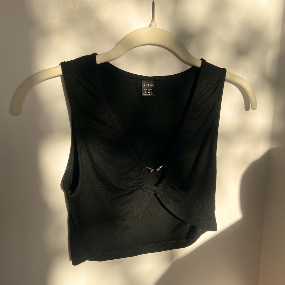 Black crop top with ring heart in middle. Size: XS condition: worn once